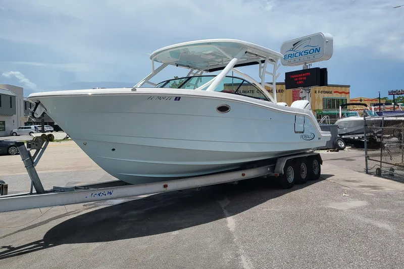 The Image of 2024 Robalo R317 Dual Console boat on trailer at Erickson Marine dealership. - 0