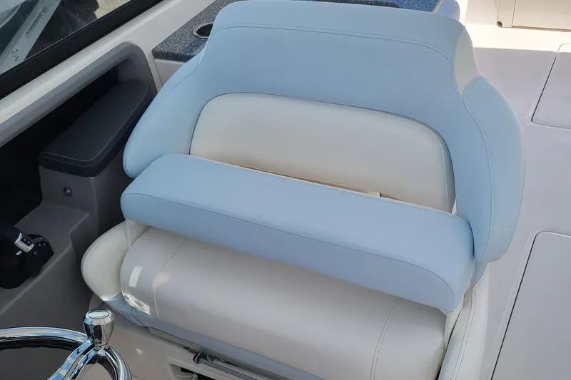 Slide: The Image of 2024 Robalo R317 Dual Console boat seat with light blue and white upholstery. - 10