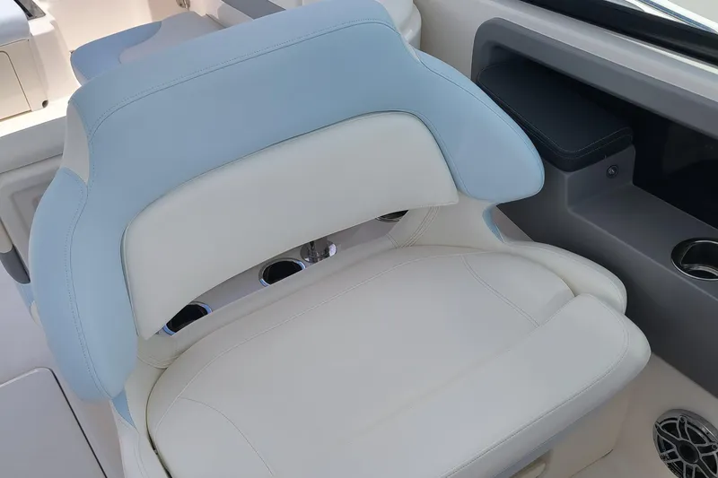 Slide: The Image of 2024 Robalo R317 Dual Console boat seat with light blue and white upholstery. - 11