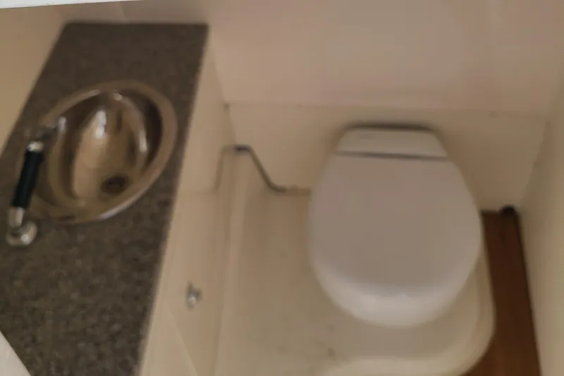 Slide: The Image of 2024 Robalo R317 Dual Console boat bathroom with sink and toilet. - 14