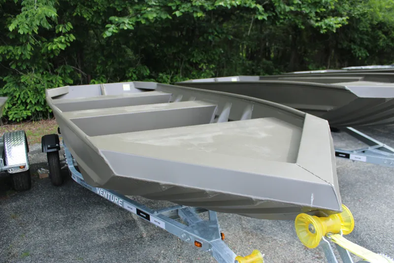 Slide: The Image of 2025 WeldBilt 1548V boat on trailer, surrounded by greenery. - 1