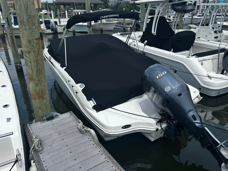 Slide: The Image of 2018 Chaparral 21 H2O Sport OB boat docked with cover and Yamaha outboard motor. - 11