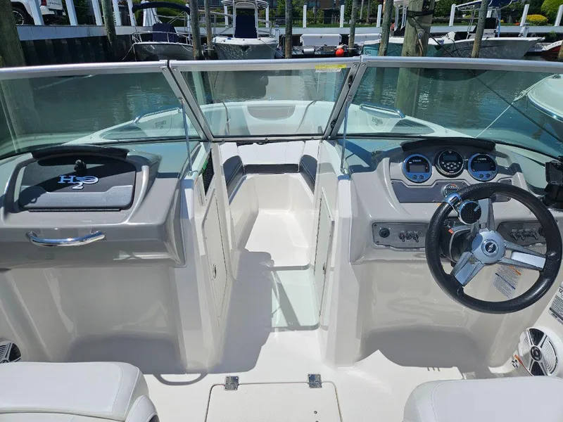 Slide: The Image of 2018 Chaparral 21 H2O Sport OB boat interior with steering wheel and dashboard. - 13