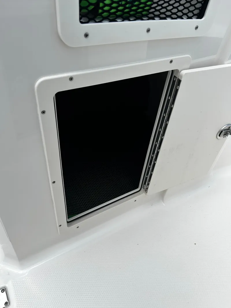 Slide: The Image of Open storage compartment on a 2018 Chaparral 21 H2O Sport OB boat. - 29