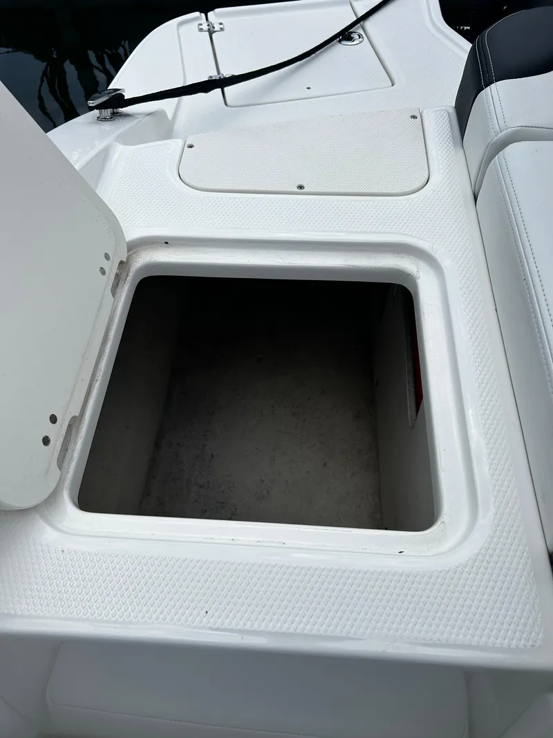 Slide: The Image of Open storage compartment on 2018 Chaparral 21 H2O Sport OB boat. - 30