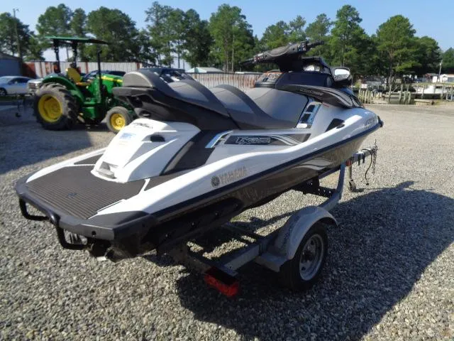 Slide: The Image of 2015 Yamaha WaveRunner FX Cruiser H/O on trailer, parked on gravel with trees in background. - 8
