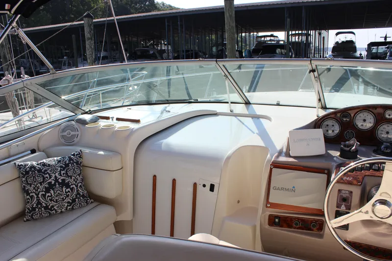 Slide: The Image of 2004 Rinker 342 Express Cruiser cockpit with Garmin navigation, plush seating, and elegant dashboard. - 12