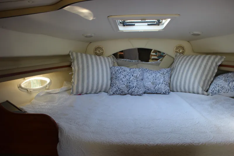 Slide: The Image of Interior cabin of 2004 Rinker 342 Express Cruiser with cozy bedding and pillows. - 22