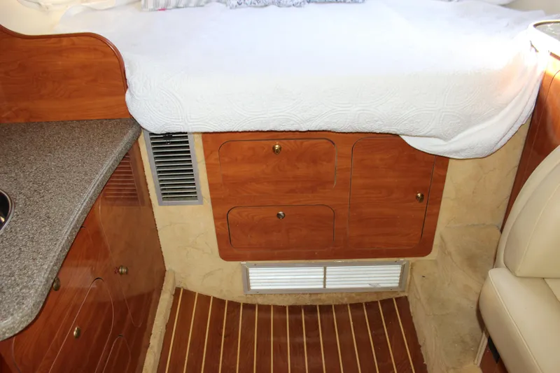 Slide: The Image of Interior of 2004 Rinker 342 Express Cruiser with wood cabinetry and bed. - 23
