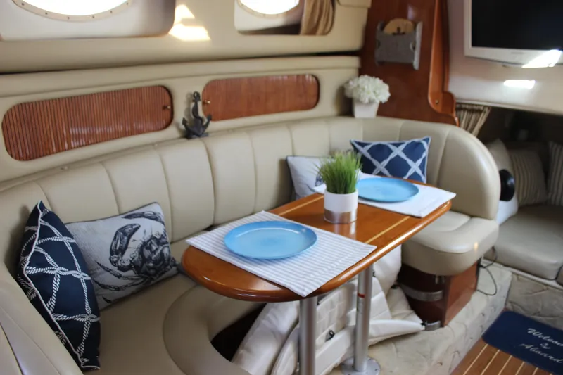 Slide: The Image of 2004 Rinker 342 Express Cruiser interior with elegant dining setup and nautical decor. - 25