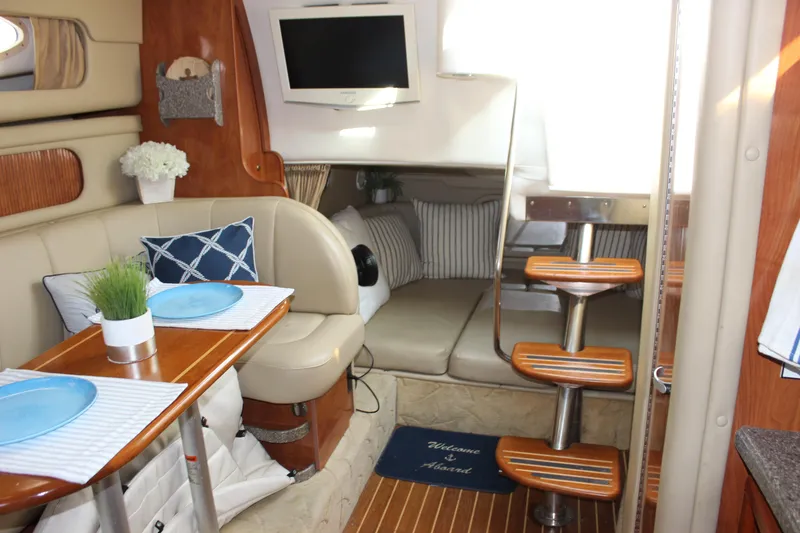 Slide: The Image of Interior of 2004 Rinker 342 Express Cruiser with cozy seating and dining area. - 26