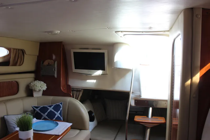 Slide: The Image of Interior of 2004 Rinker 342 Express Cruiser with cozy seating and mounted TV. - 27
