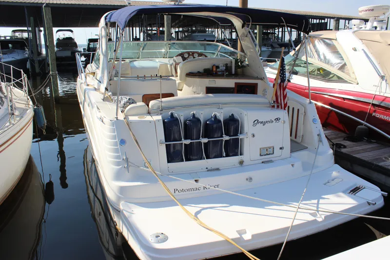 Slide: The Image of 2004 Rinker 342 Express Cruiser docked at marina with American flag. - 3