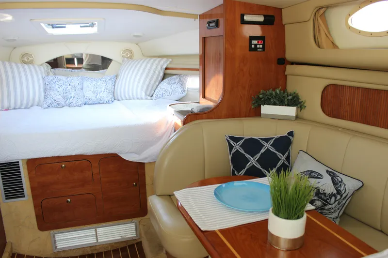 Slide: The Image of Interior of 2004 Rinker 342 Express Cruiser with cozy bed and dining area. - 19