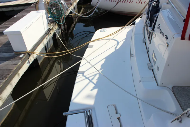 Slide: The Image of 2004 Rinker 342 Express Cruiser docked with ropes and equipment visible. - 6