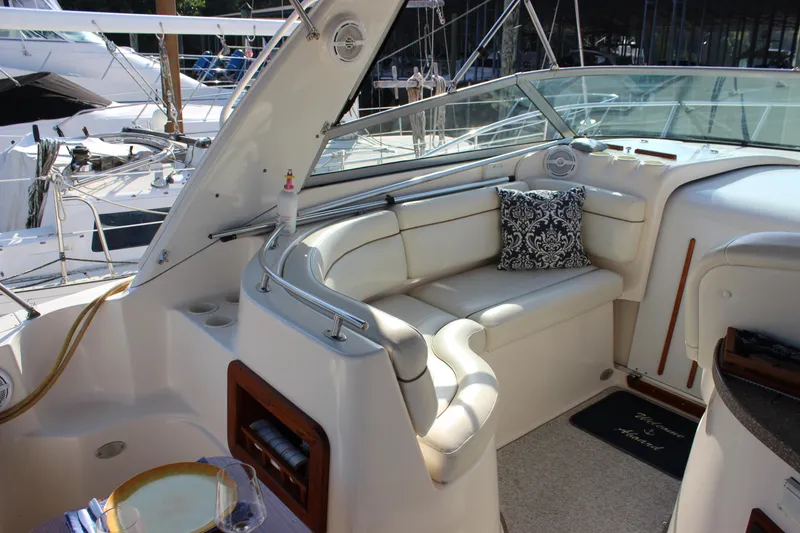 Slide: The Image of 2004 Rinker 342 Express Cruiser interior with white seating and decorative pillow. - 8