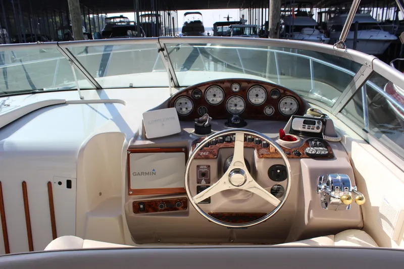 Slide: The Image of 2004 Rinker 342 Express Cruiser dashboard with Garmin navigation and control instruments. - 11
