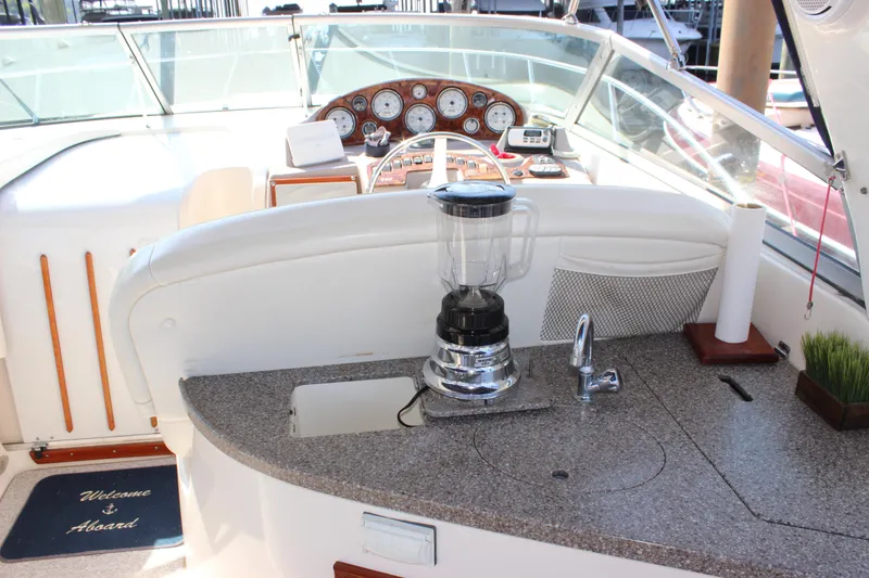 Slide: The Image of 2004 Rinker 342 Express Cruiser cockpit with blender, sink, and dashboard controls. - 29