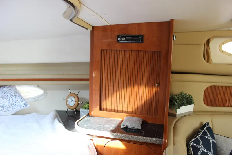 Slide: The Image of Interior of 2004 Rinker 342 Express Cruiser with wood paneling and cozy decor. - 24