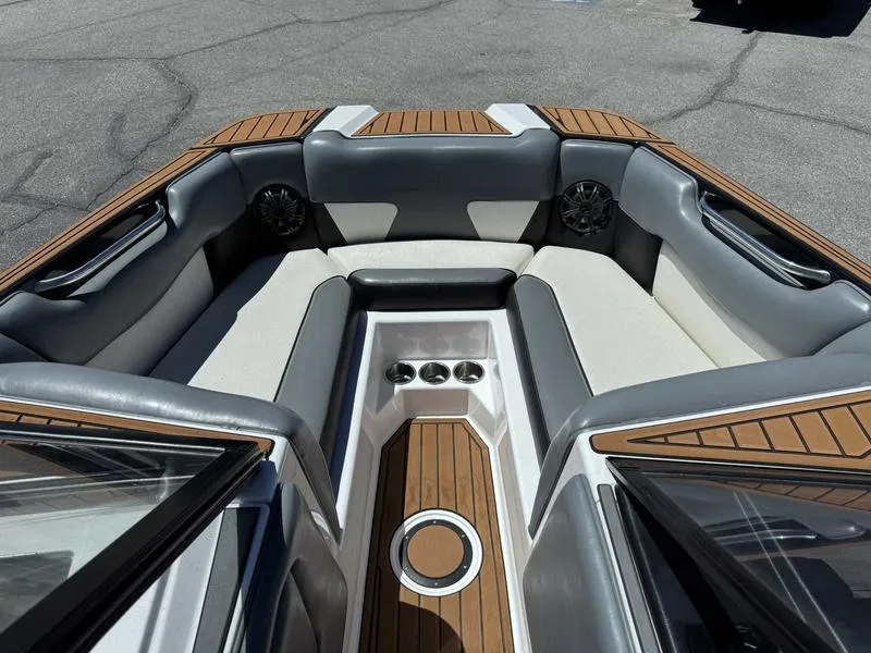Slide: The Image of 2017 Moomba Helix boat interior with cushioned seating and wood accents. - 21