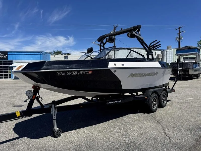 Slide: The Image of 2017 Moomba Helix boat on trailer in parking lot, clear sky background. - 6