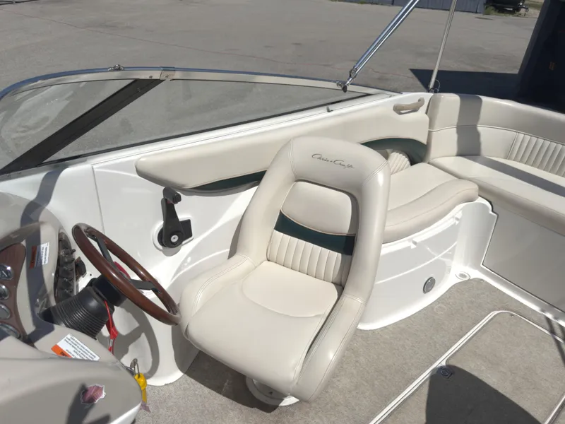Slide: The Image of 1999 Chris-Craft 210 Bowrider interior with steering wheel and seating. - 10