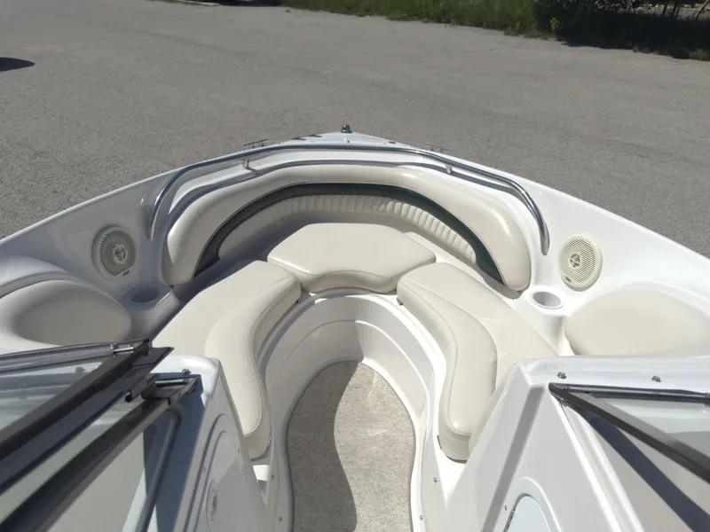 Slide: The Image of 1999 Chris-Craft 210 Bowrider interior with white seating and speakers. - 11