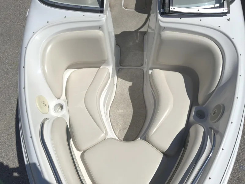 Slide: The Image of 1999 Chris-Craft 210 Bowrider interior with beige seating and carpeted floor. - 8