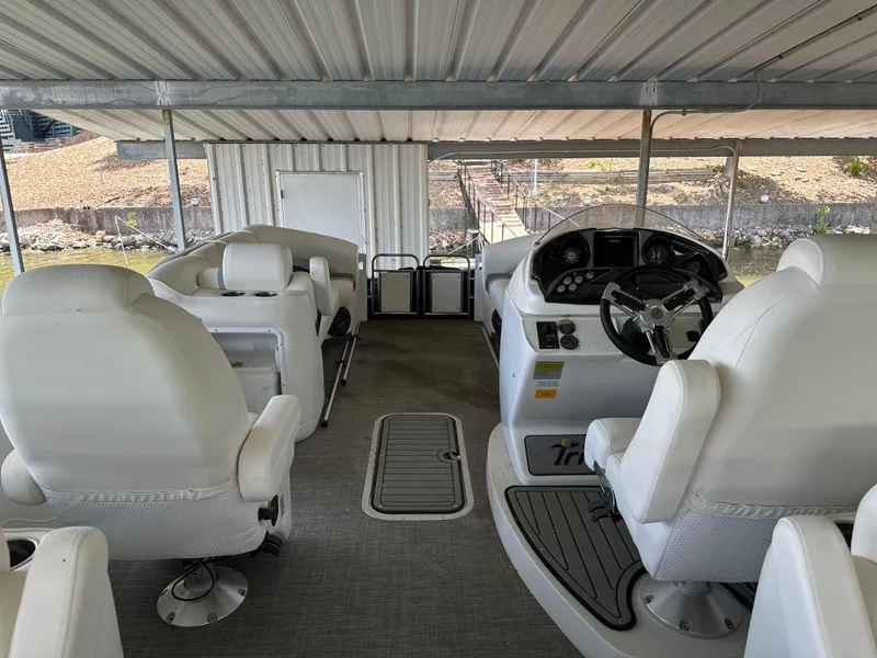 Slide: The Image of 2017 JC 25 Neptoon TT Sport boat interior with white seating and steering console. - 10
