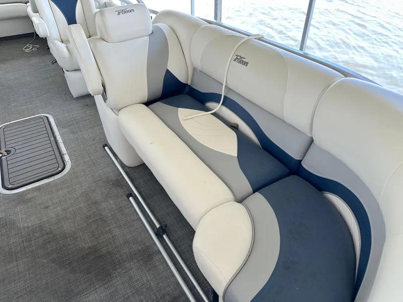 Slide: The Image of Interior seating of 2017 JC 25 Neptoon TT Sport pontoon boat, featuring white and blue upholstery. - 12