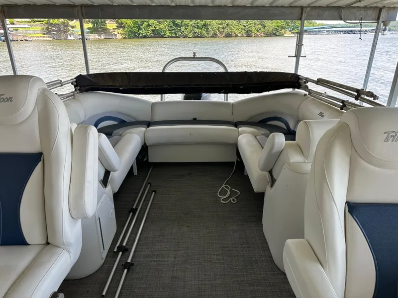 Slide: The Image of 2017 JC 25 Neptoon TT Sport pontoon boat interior with white seating and lake view. - 13