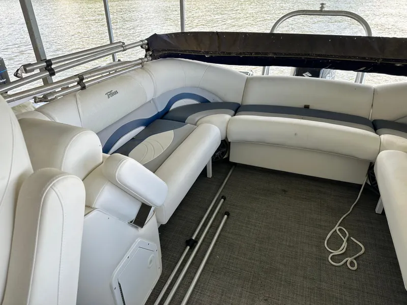 Slide: The Image of 2017 JC 25 Neptoon TT Sport boat interior with white seating and lake view. - 14