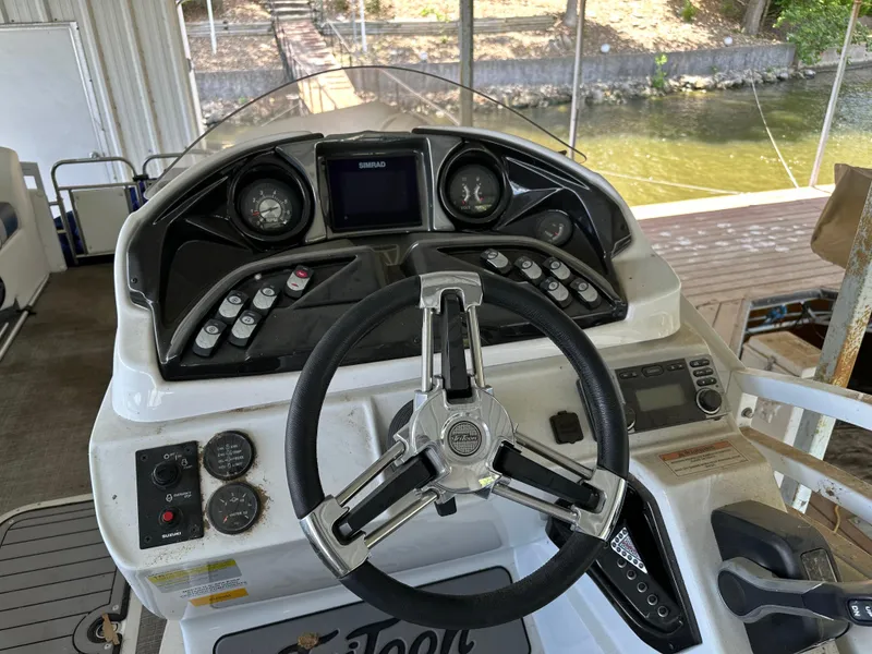Slide: The Image of 2017 JC 25 Neptoon TT Sport boat dashboard with steering wheel and controls. - 18