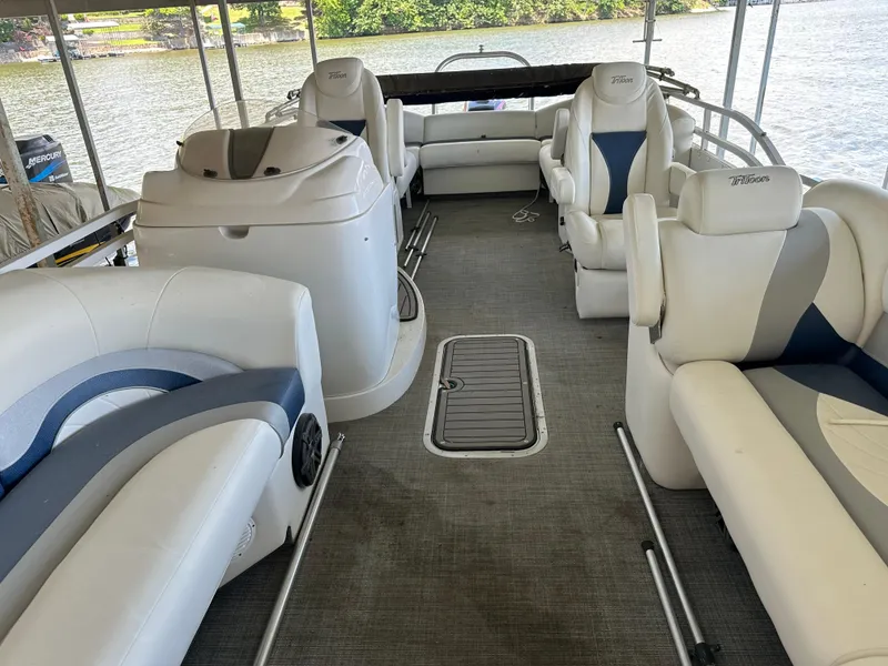Slide: The Image of Interior of a 2017 JC 25 Neptoon TT Sport pontoon boat with white seating. - 2