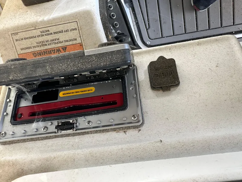 Slide: The Image of Control panel of a 2017 JC 25 Neptoon TT Sport boat, partially open. - 23