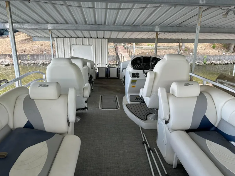 Slide: The Image of 2017 JC 25 Neptoon TT Sport pontoon boat interior with white seating and steering console. - 26