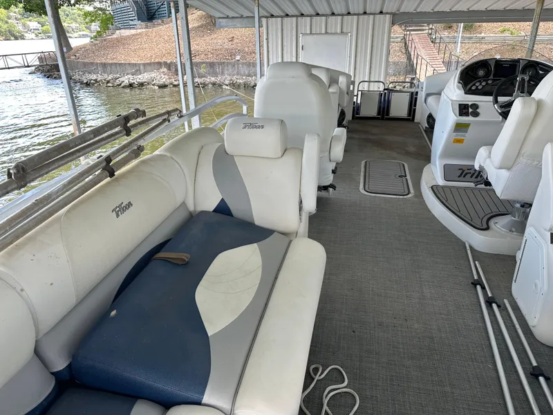 Slide: The Image of 2017 JC 25 Neptoon TT Sport pontoon boat interior with seating and steering console. - 28