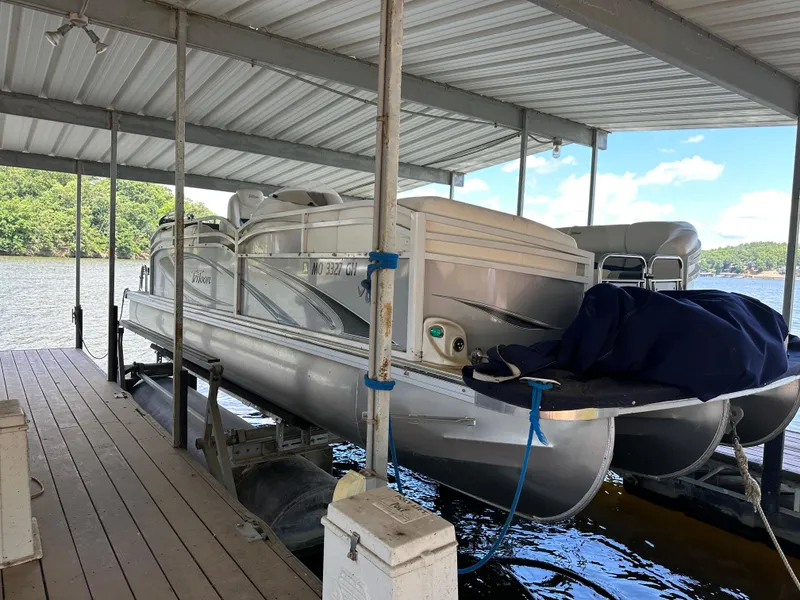 Slide: The Image of 2017 JC 25 Neptoon TT Sport pontoon boat docked under a covered structure. - 5