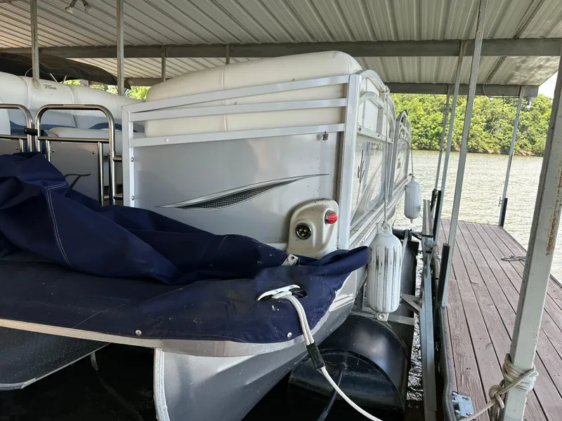 Slide: The Image of 2017 JC 25 Neptoon TT Sport pontoon boat docked under a covered structure. - 7