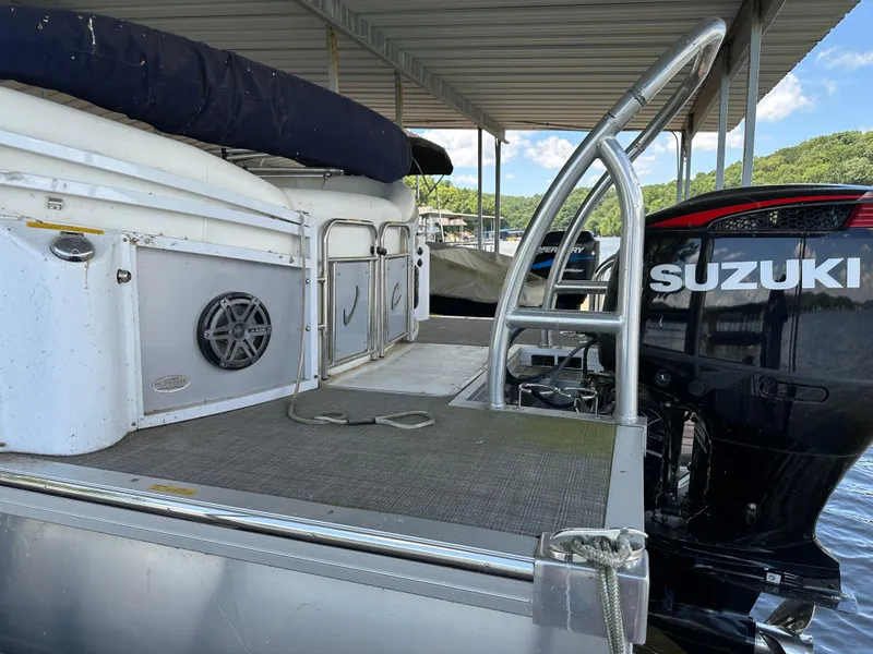 Slide: The Image of 2017 JC 25 Neptoon TT Sport pontoon boat with Suzuki outboard motor at dock. - 9