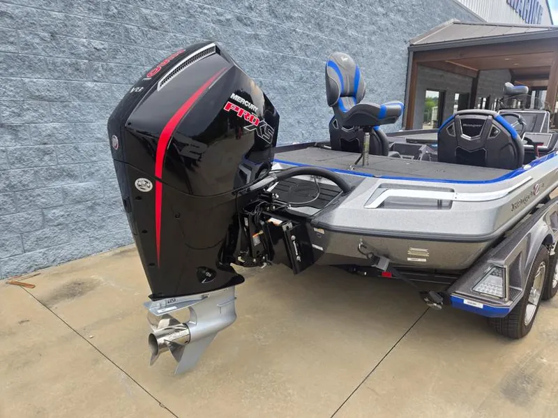 Slide: The Image of 2024 Ranger Z521R boat with Mercury Pro XS engine, parked on concrete. - 9