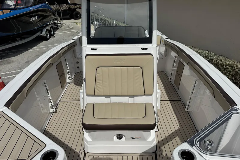 Slide: The Image of 2025 Yamaha Boats 252 FSH Sport interior with beige seating and sleek design. - 16