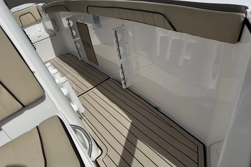 Slide: The Image of 2025 Yamaha Boats 252 FSH Sport interior with beige seating and sleek flooring. - 19