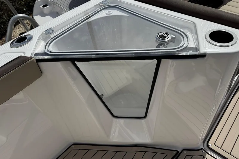 Slide: The Image of 2025 Yamaha Boats 252 FSH Sport deck with storage compartment and cup holders. - 21