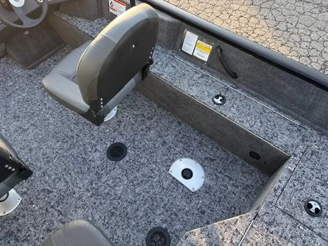 Slide: The Image of 2026 Tracker Pro Guide V-16 WT boat interior with gray seating and carpeted flooring. - 11