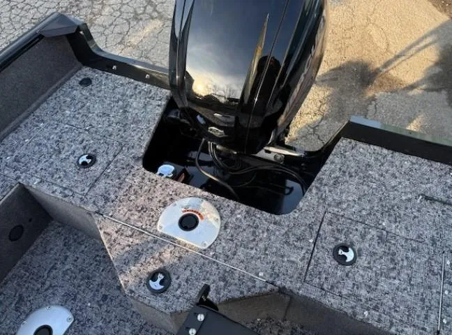 Slide: The Image of 2026 Tracker Pro Guide V-16 WT boat with motor, textured deck, and fishing rod holders. - 12