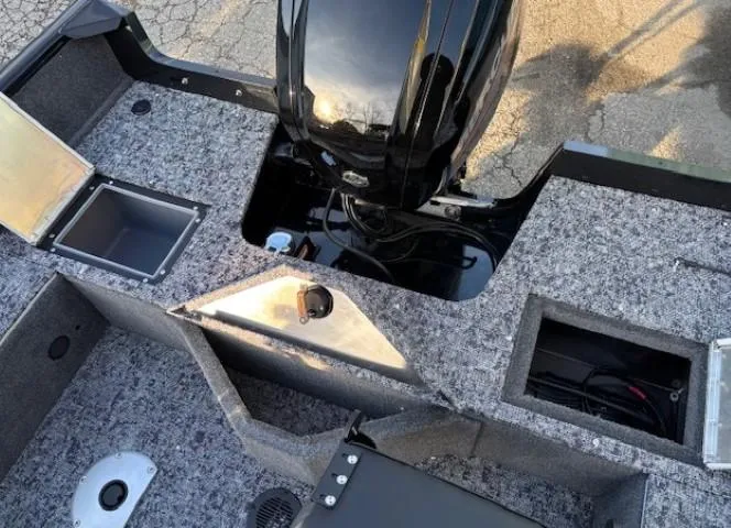 Slide: The Image of 2026 Tracker Pro Guide V-16 WT boat interior with storage compartments and motor. - 13