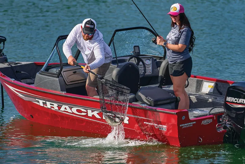 Slide: The Image of 2026 Tracker Pro Guide V-16 WT boat on water with two people fishing. - 14