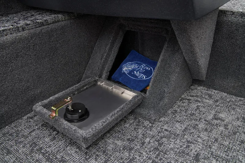 Slide: The Image of 2026 Tracker Pro Guide V-16 WT boat storage compartment with carpeted interior and secure latch. - 19