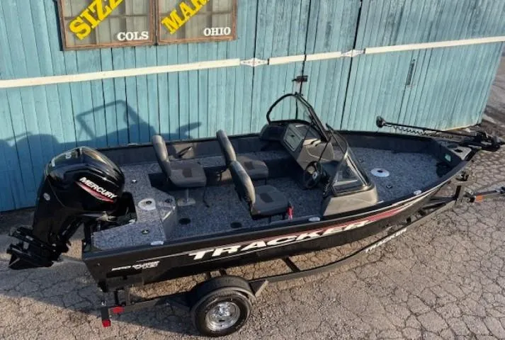 Slide: The Image of 2026 Tracker Pro Guide V-16 WT fishing boat with Mercury engine, parked on trailer. - 5